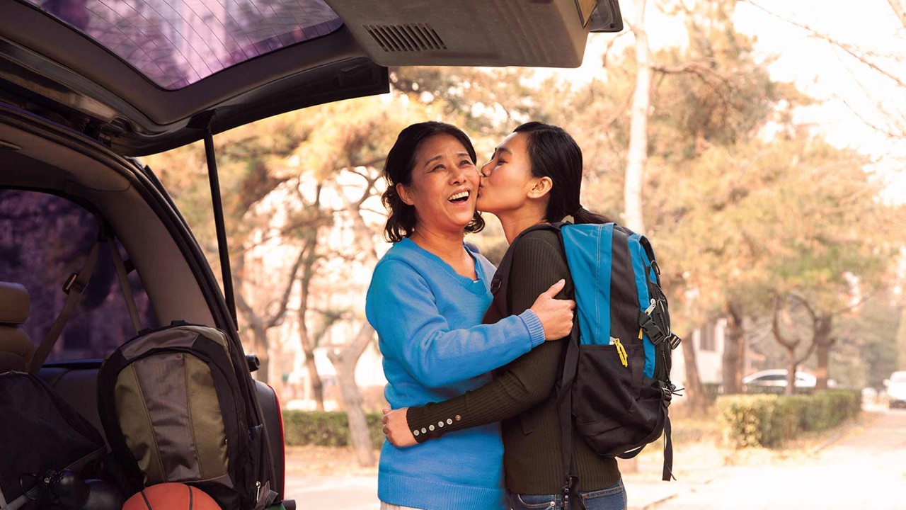 daughter kissing mother on the cheek