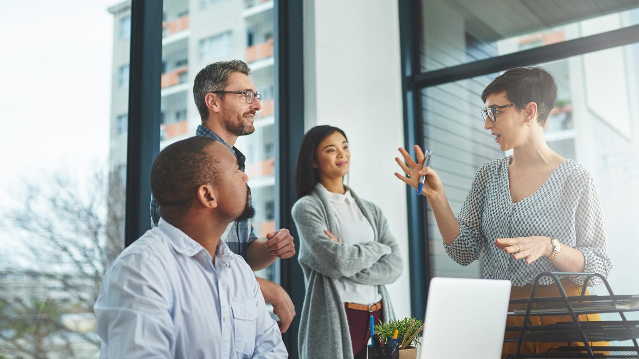 four people in a work meeting