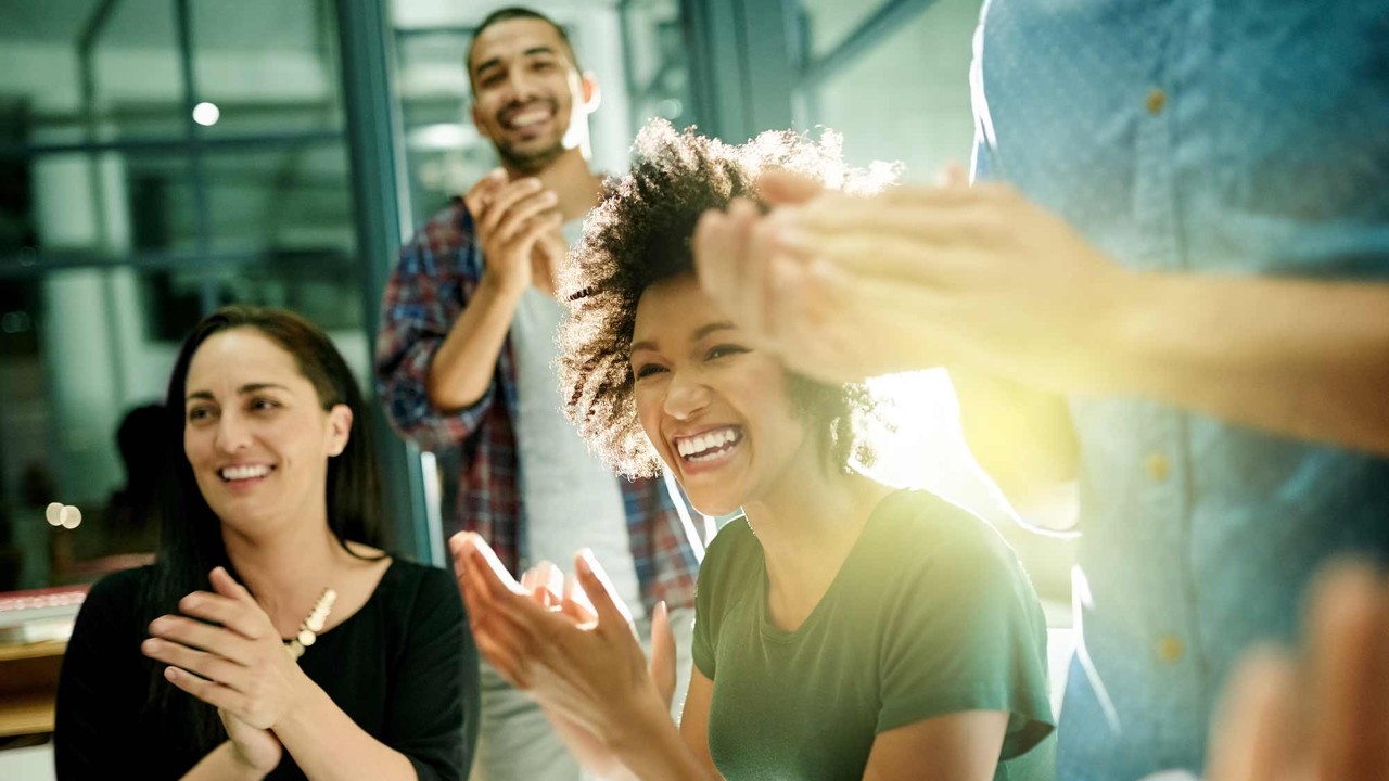 people clapping in a meeting