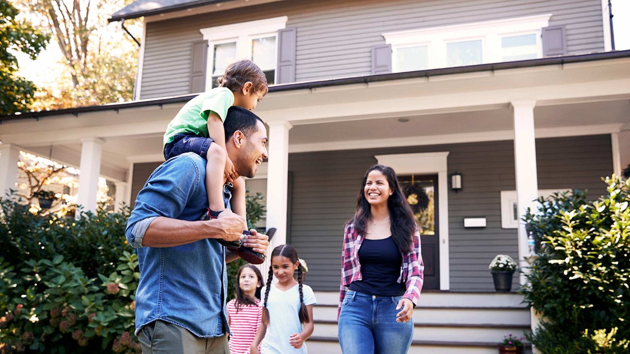 family in front of a house