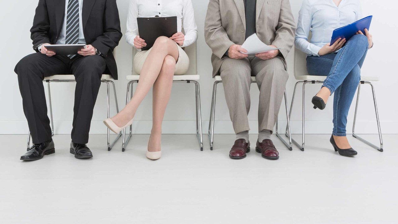 legs of people sitting in chairs